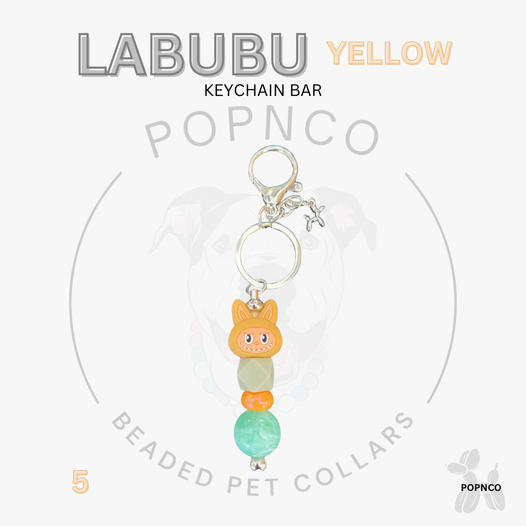 Yellow keychain bar with a cat-shaped charm on a white background, featuring the brand 'LABUBU' and 'POPNCO'.