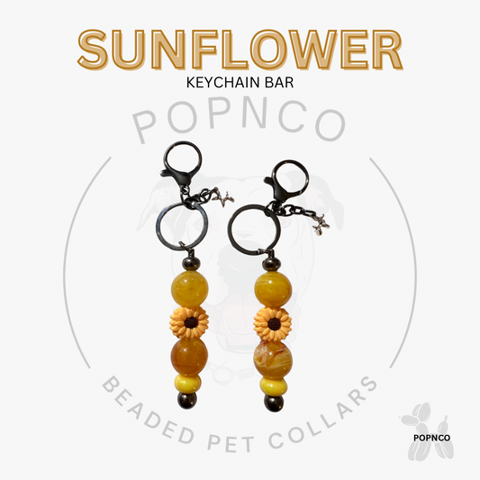 Sunflower keychain bar with beads on a white background, featuring the brand 'POPNCO'.