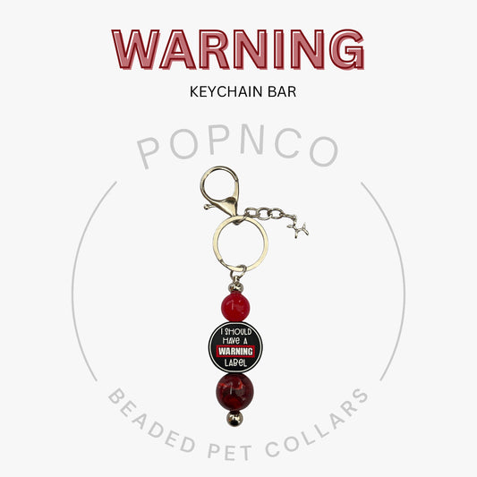 Keychain bar with red beads and a warning label on a white background, featuring the brand 'POPNCO'.