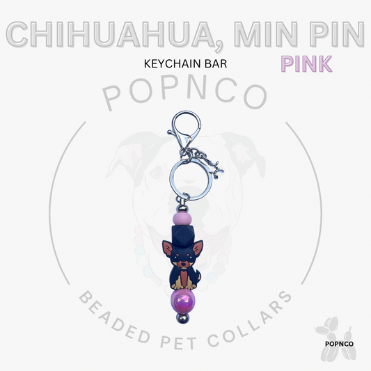 Pink keychain bar with chihuahua and min pin dog charms on a white background