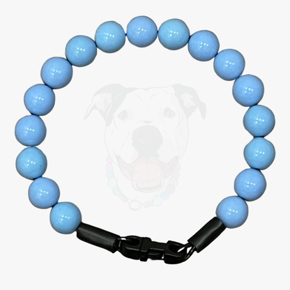 Blue beaded bracelet with a black clasp on a white background