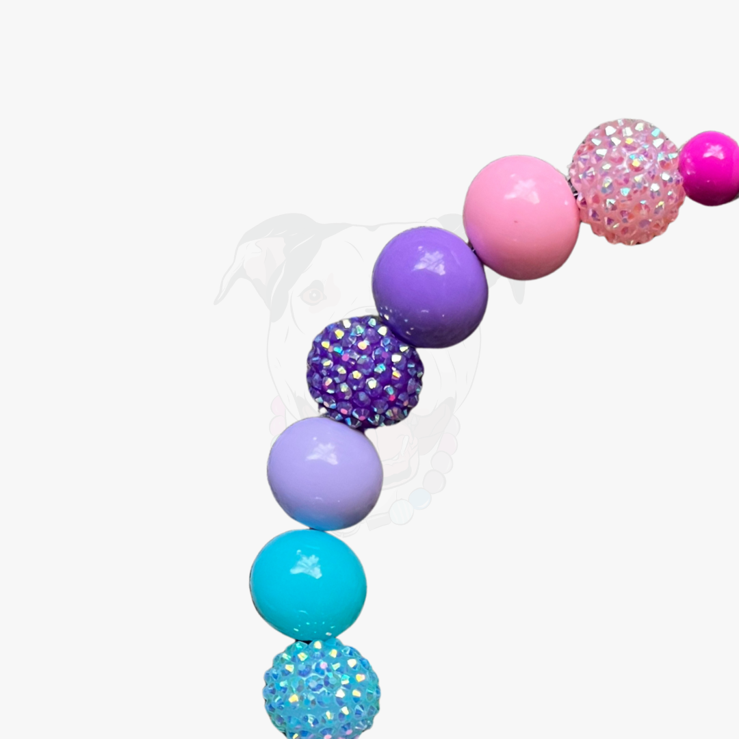Colorful bubblegum bead necklace on a white background