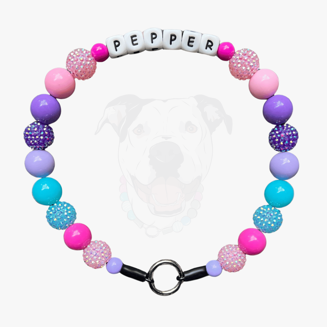 POPNCO Add On Alphabet Silicone Beads 12mm POPNCO Leighton Beaded Pet Collar. Pink, Purple and teal beaded pet collar alternating and mixing solids and rhinestone bayberries on aircraft grade stainless steel wire.Leighton POPNCO Pink, Purple and teal beaded pet collar alternating and mixing solids and rhinestone bayberries. the collar also has the name pepper on it and is laying flat on a white background