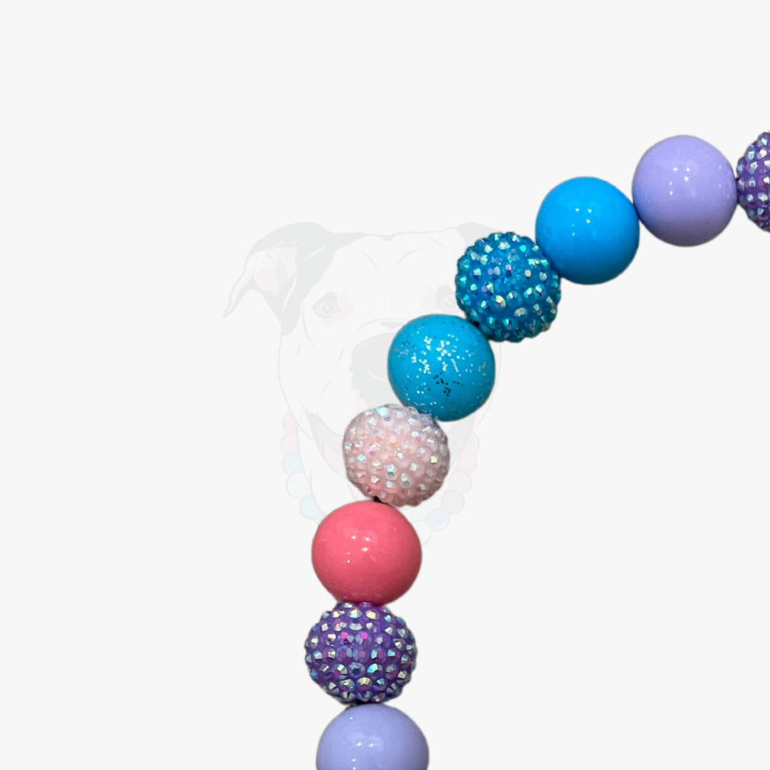 Colorful bubblegum ball arch with rhinestone accents on a white background