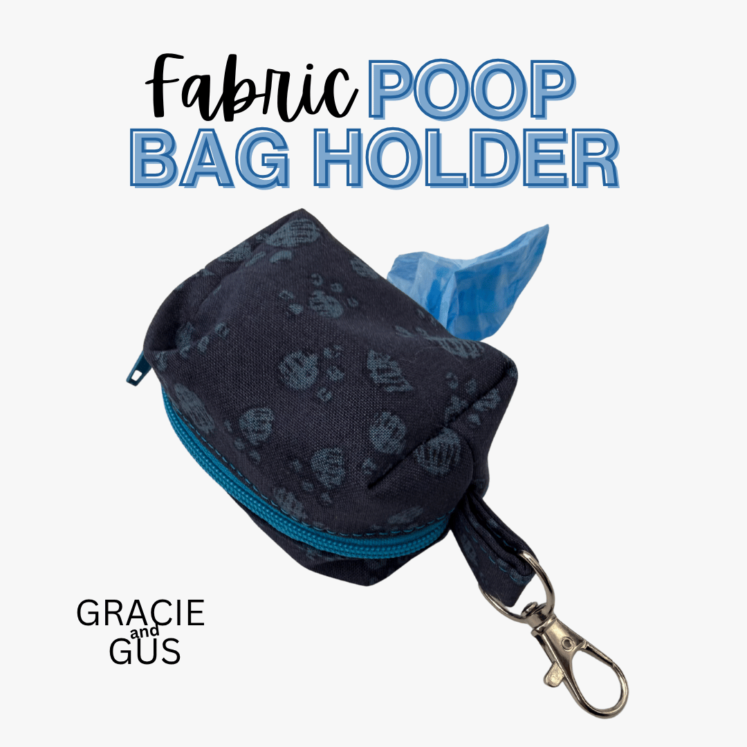 A fabric poop bag holder pouch in dark navy with a subtle paw print pattern, a bright blue zipper, and a silver clasp, shown with a blue plastic bag partially tucked inside. Text at the top reads 'Fabric POOP BAG HOLDER' and the bottom left shows the brand 'GRACIE and GUS'.