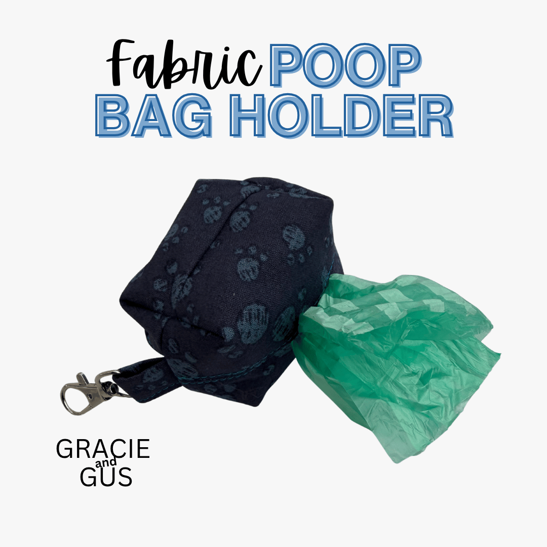 A fabric poop bag holder in dark navy blue with a subtle paw print pattern, shown with a green plastic bag partially pulled out. The text 'Fabric POOP BAG HOLDER' is displayed at the top, and the brand 'GRACIE AND GUS' is shown at the bottom left on a light gray background.