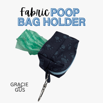 A fabric poop bag holder pouch in dark navy with a subtle paw print pattern, shown with a green plastic bag protruding from the opening and a silver clasp. Large text at the top reads 'Fabric POOP BAG HOLDER' and 'GRACIE and GUS' appears at bottom left on a light gray background.