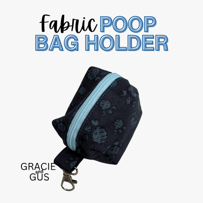 A fabric poop bag holder pouch with a dark navy blue paw-print pattern and a light blue zipper, shown on a white background with text reading 'Fabric POOP BAG HOLDER' and 'GRACIE and GUS'.