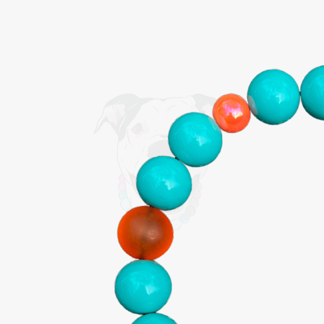 Necklace with turquoise and orange beads on a white background