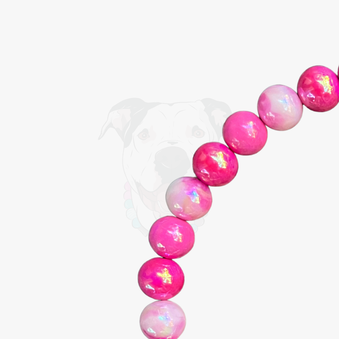 Pink and white beaded bracelet on a white background