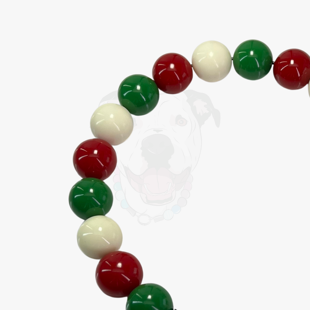 Bracelet with red, green, and white beads on a white background