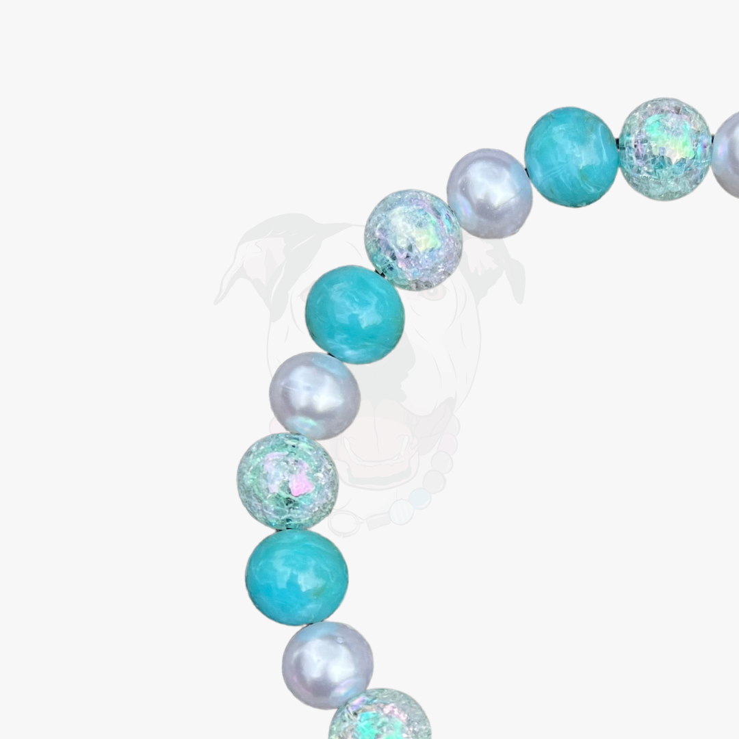 Beaded bracelet with turquoise, white, and iridescent beads on a white background POPNCO