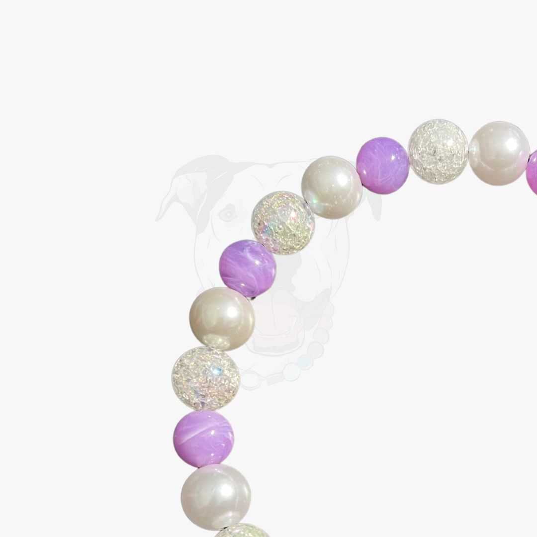 Beaded bracelet with purple and white beads on a white background
