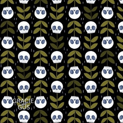 A repeating pattern of white skulls with blue eyes and olive green leaves on a black background, with the text 'GRACIE GUS' in the lower left corner.