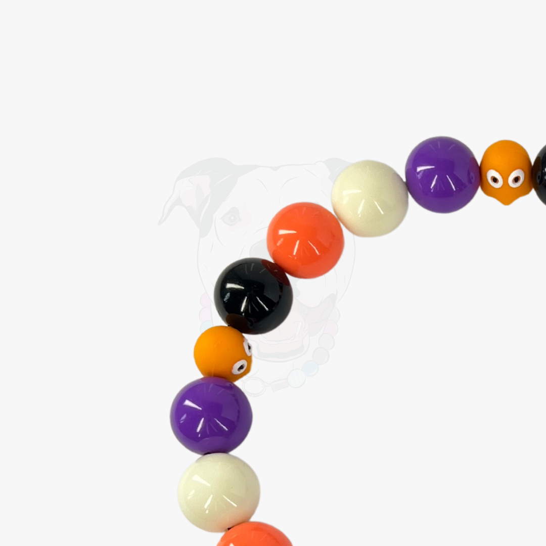 Colorful beaded bracelet with various colored beads on a white background