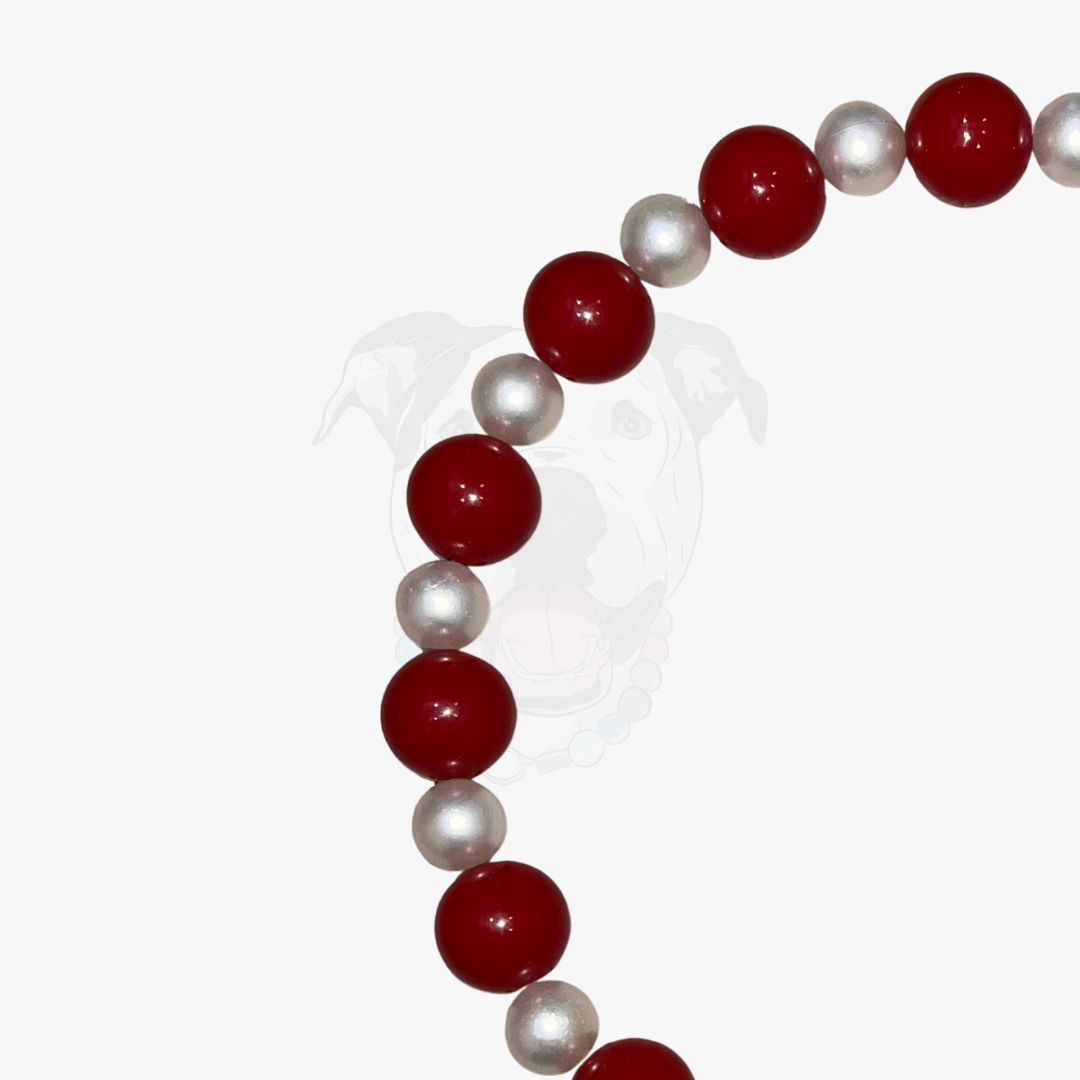Beaded bracelet with red and white pearls on a white background