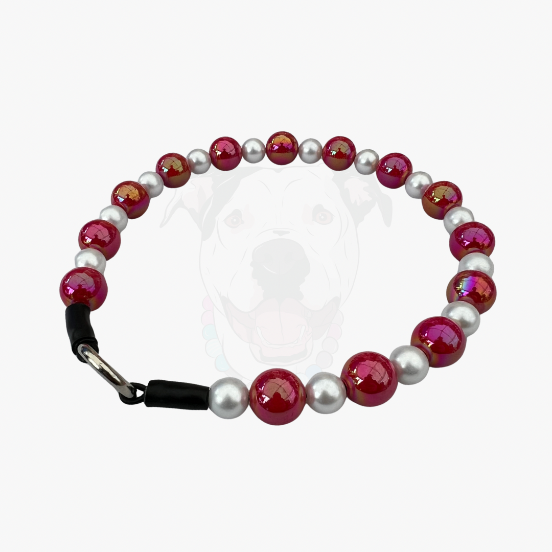 Beaded bracelet with red and white beads on a clear background