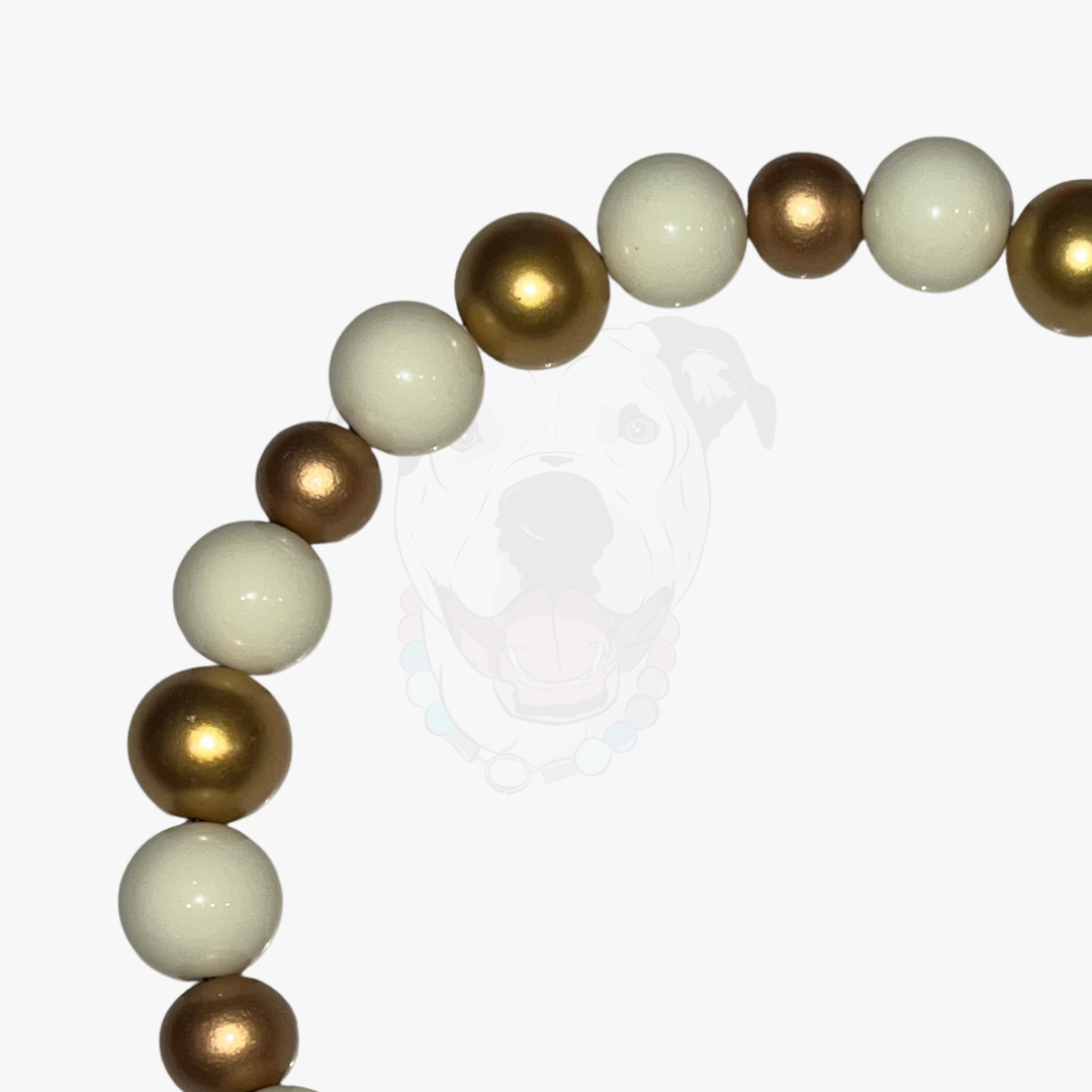 Bracelet with gold and white beads on a white background