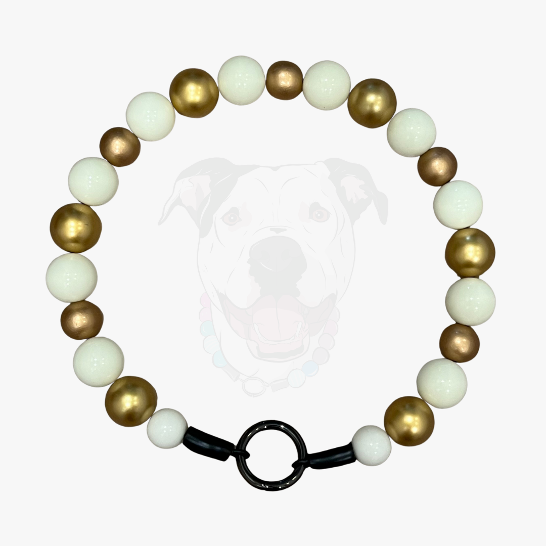 Bracelet with gold, white, and brown beads on a white background