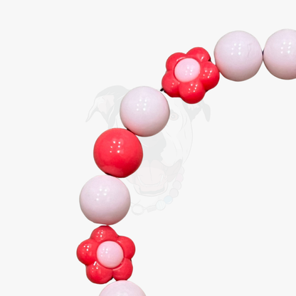 Decorative balloon arch with pink and white balloons on a white background