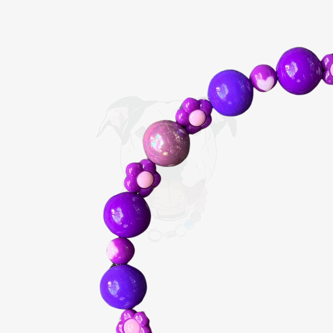 Purple and pink beaded bracelet on a white background