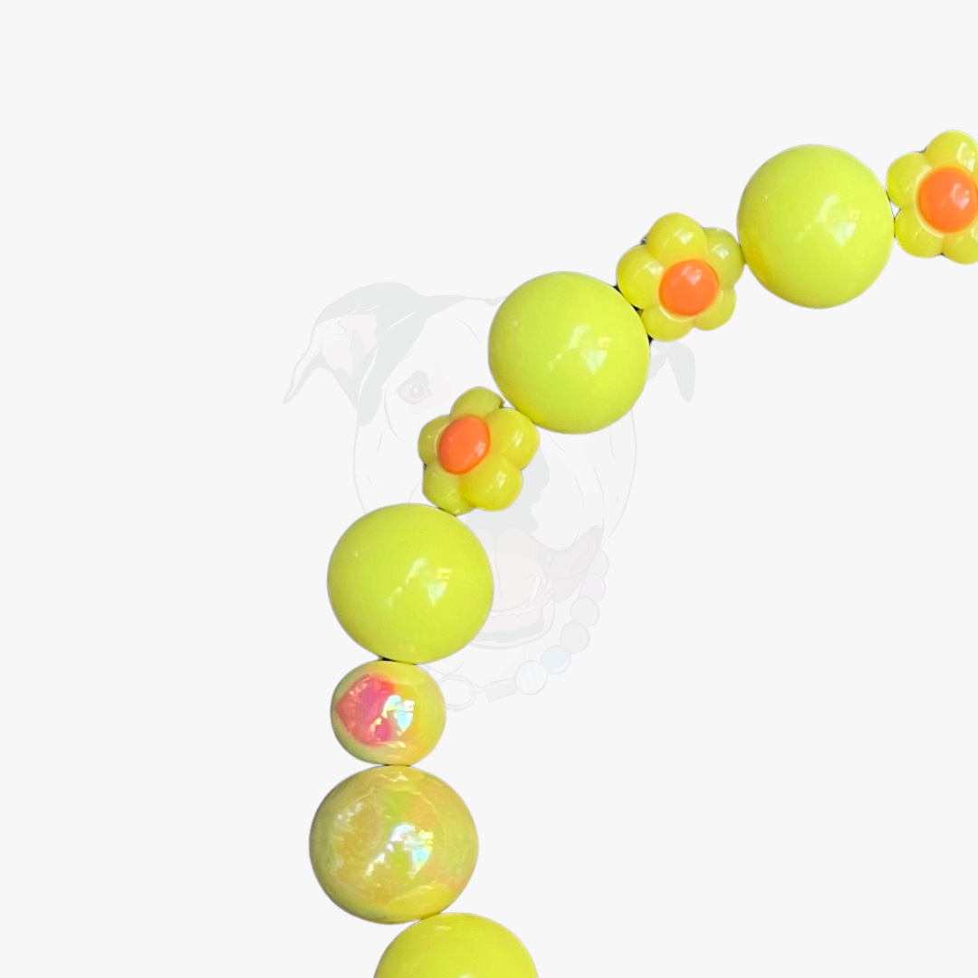 Neon yellow beaded bracelet with orange and pink accents on a white background