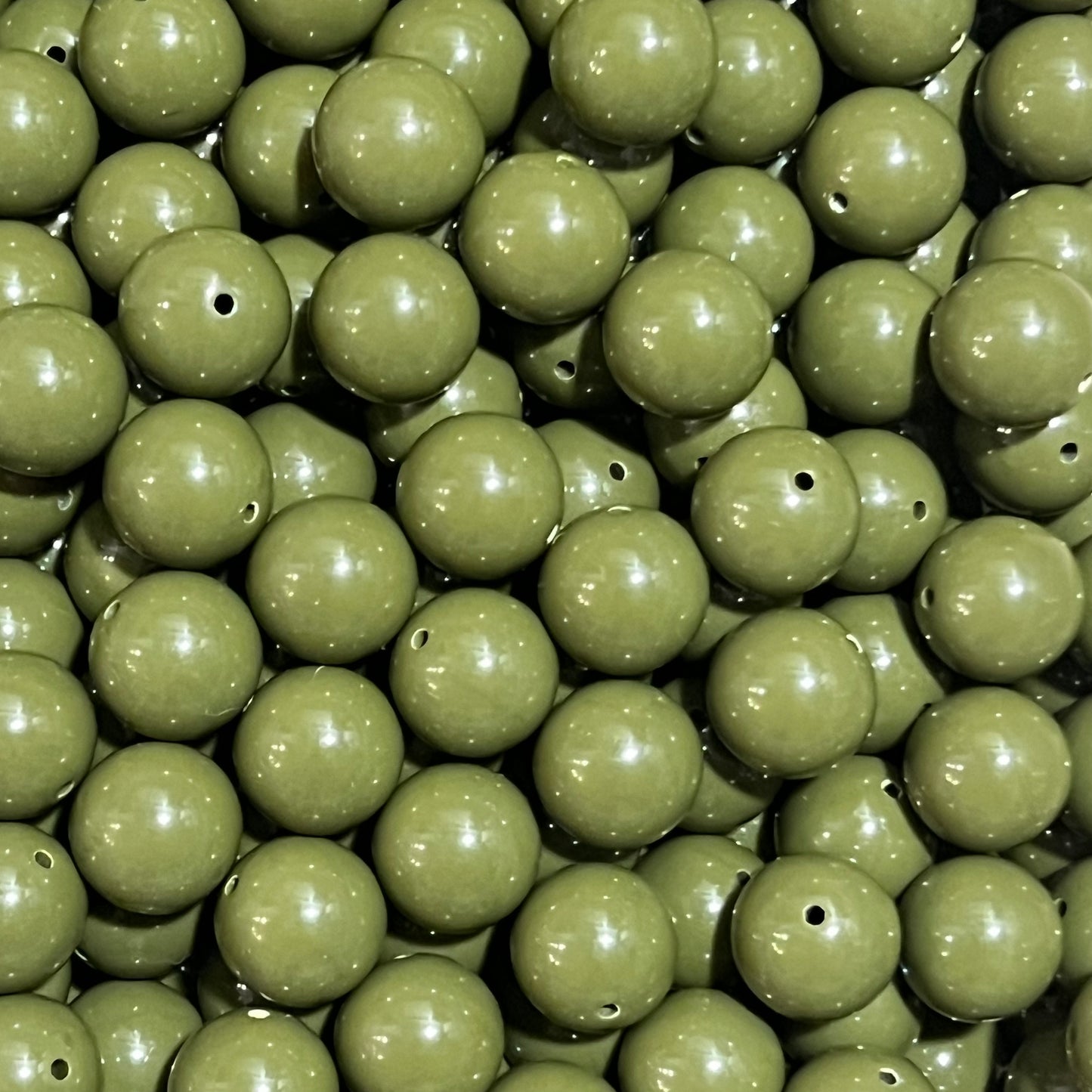 Close-up of green beads with a focus on texture and color.