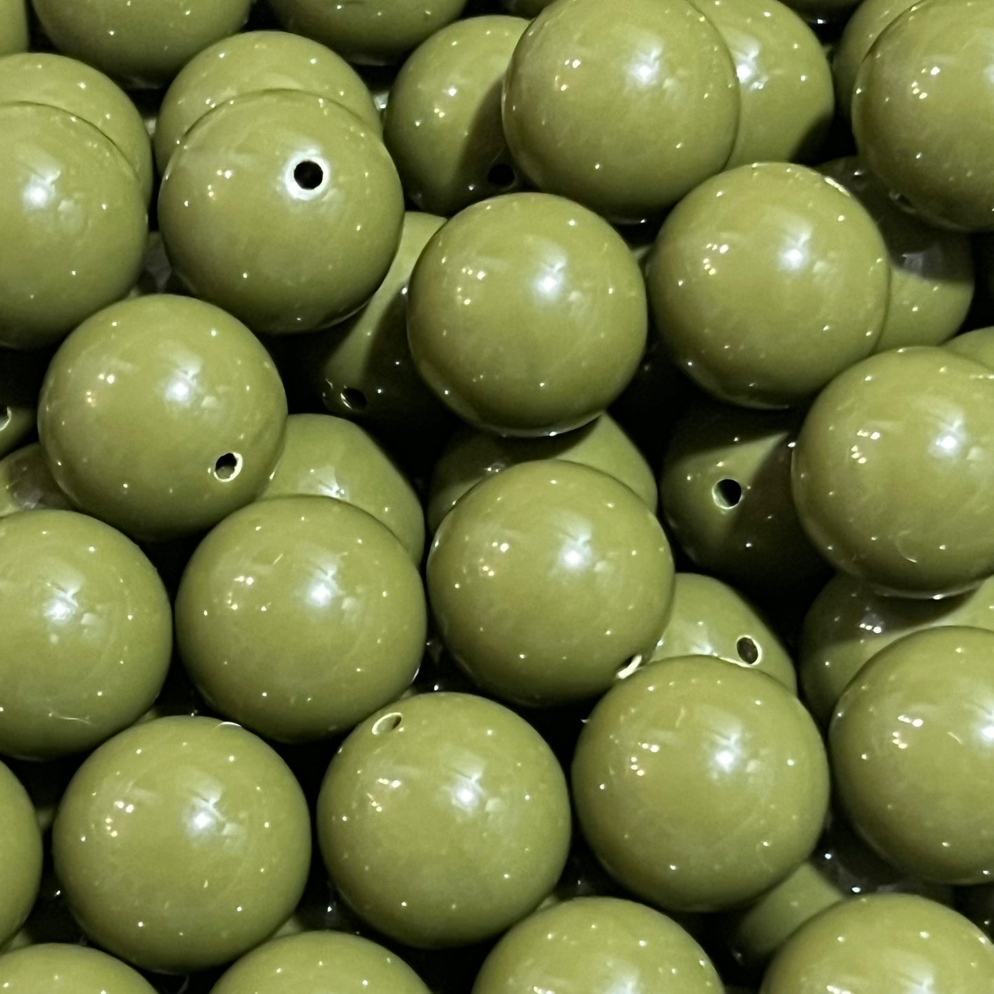Close-up of green beads with a focus on texture and color.