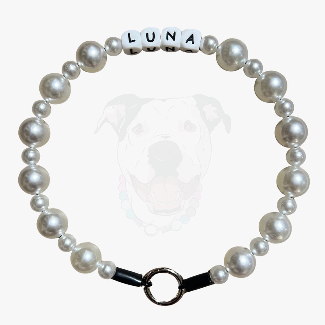 Pearl bracelet with 'LUNA' name tag on a white background