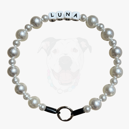 Pearl bracelet with 'LUNA' name tag on a white background