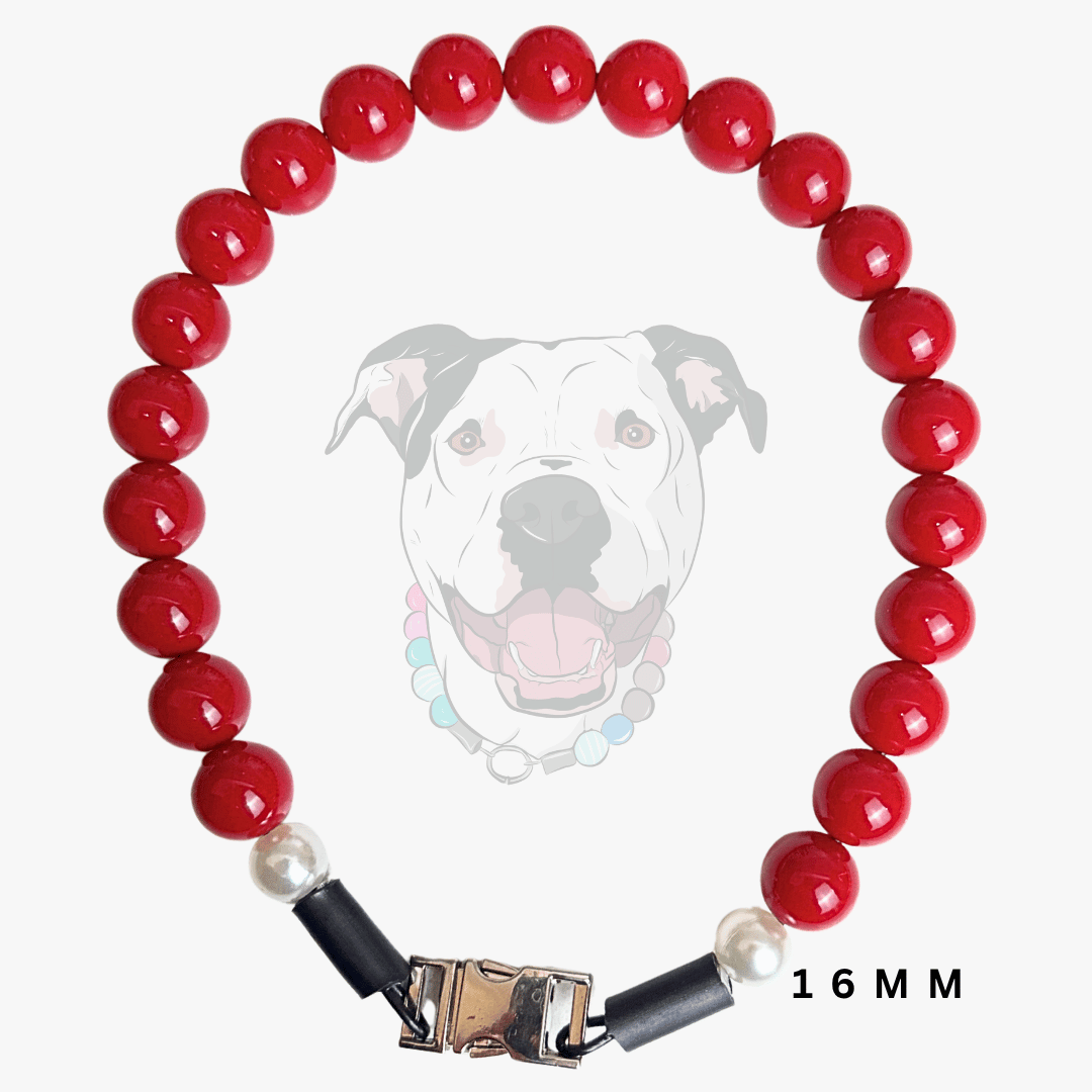 A red beaded dog collar with white pearl-like beads, black end caps, and a gold-toned metal clasp, shown on a light gray background with a faint dog illustration and '16 MM' text.