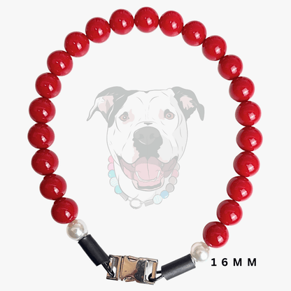 A red beaded dog collar with white pearl-like beads, black end caps, and a gold-toned metal clasp, shown on a light gray background with a faint dog illustration and '16 MM' text.