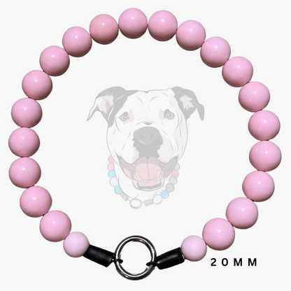 A pink beaded dog collar with a silver metal ring clasp and black end caps, displayed against a light gray background with a faint dog graphic and '20MM' text.