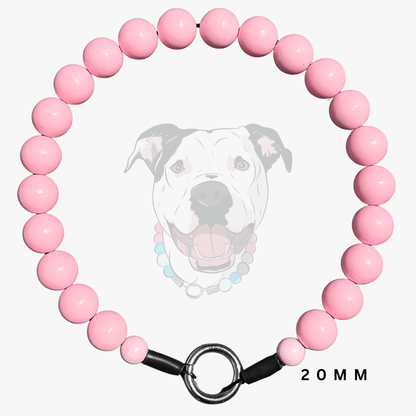 A pink beaded dog collar with a black metal ring clasp and black end caps, shown on a light gray background with a faded dog illustration and '20MM' text.