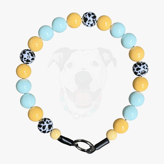 POPNCO Bonnie Beaded Pet Collar Blue and  Yellow Cow 20mm Square on White Background, featuring yellow light blue and black and white cow print acrylic beads. 