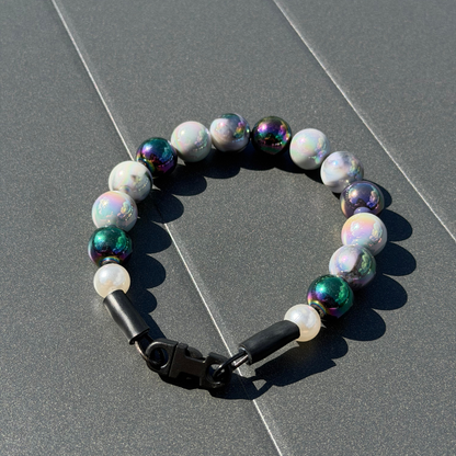 POPNCO Ciara 16mm Beaded Pet Collar. Black, White and Grey AB Shiny Acrylic and Resin Beads on Aircraft Grade Stainless Steel Wire. POPNCO Grey and Black Shiny Beaded Pet Collar laying on a grey table