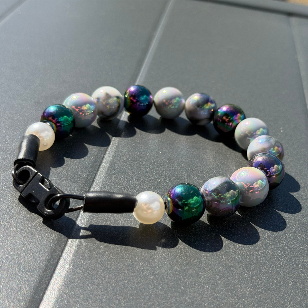 POPNCO Ciara 16mm Beaded Pet Collar. Black, White and Grey AB Shiny Acrylic and Resin Beads on Aircraft Grade Stainless Steel Wire. Black and Grey AB 16mm Shiny beaded pet collar Betty  on a gray tiled surface
