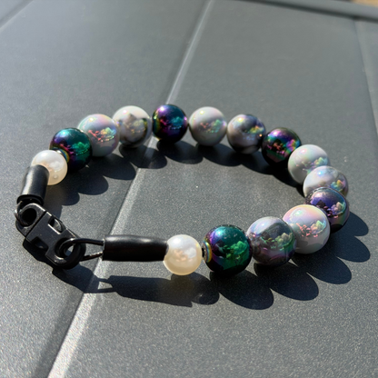 POPNCO Ciara 16mm Beaded Pet Collar. Black, White and Grey AB Shiny Acrylic and Resin Beads on Aircraft Grade Stainless Steel Wire. Black and Grey AB 16mm Shiny beaded pet collar Betty  on a gray tiled surface