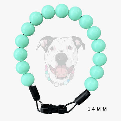 A dog beaded collar featuring 14mm mint green round beads and a black adjustable plastic buckle, shown against a light gray background with a faint dog graphic and '14 MM' text overlay.