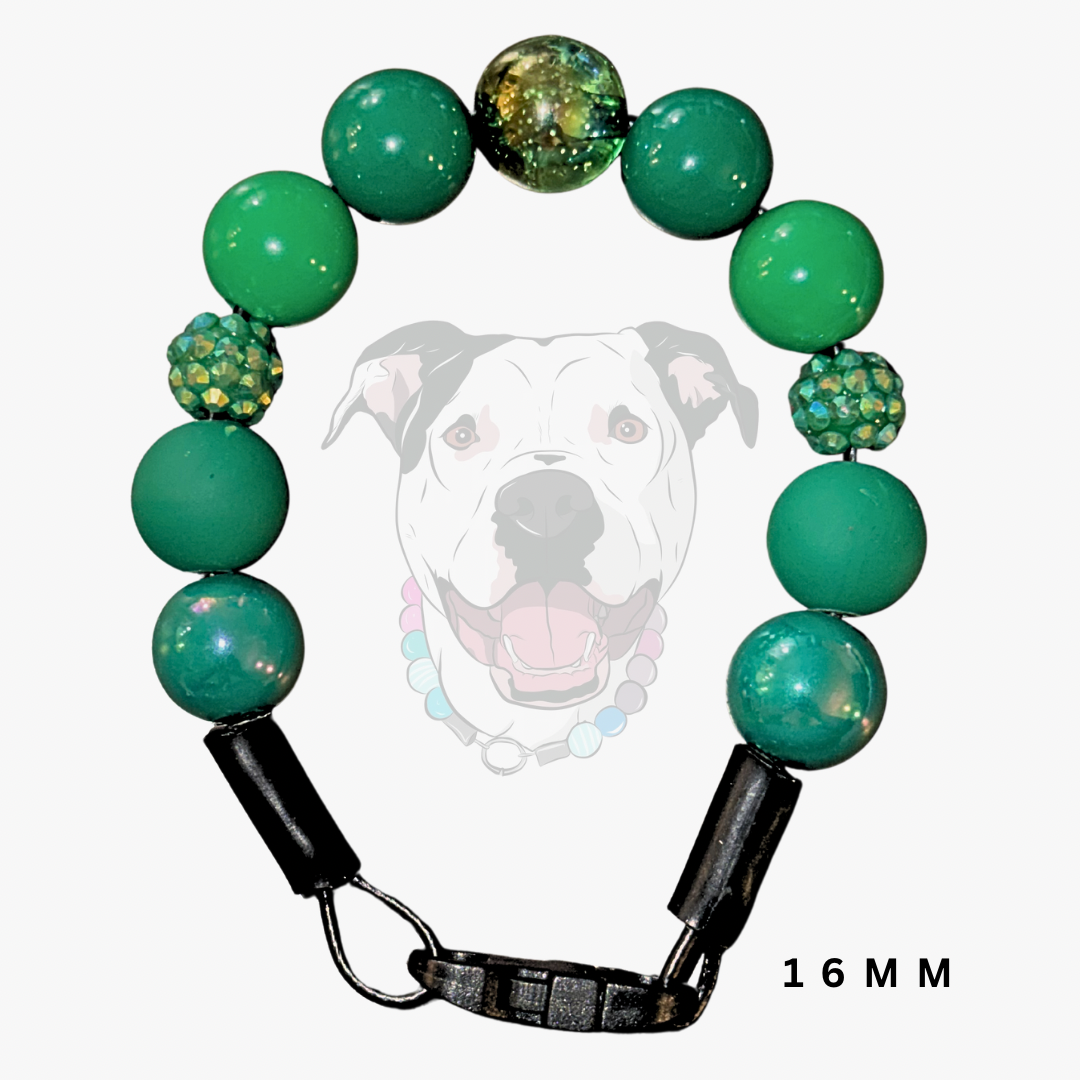 A green beaded dog collar with black plastic clamps and a metal ring, shown against a light gray background with a faint dog graphic and '16MM' text.