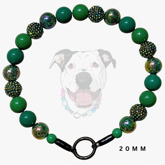 A green beaded dog collar with textured and glittery beads, featuring a black metal clasp and a faint dog graphic in the background with '20MM' text.