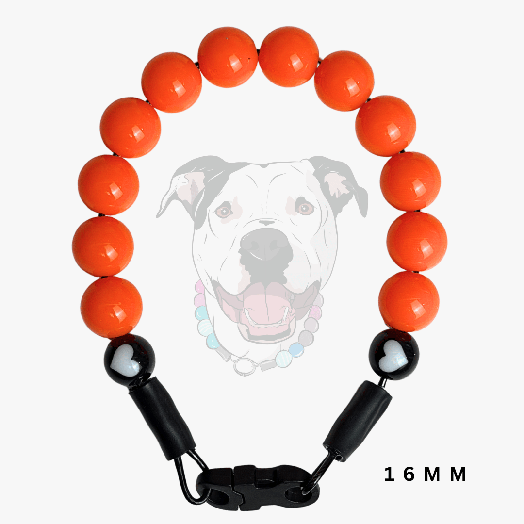 Orange beaded dog collar with black plastic clasp and heart-shaped accent beads, shown on a light gray background with a faint dog illustration and '16 MM' text.