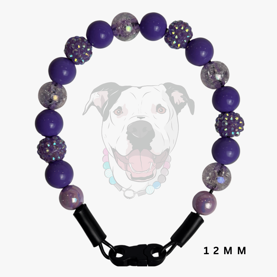 A beaded dog collar shown on a light gray background with a faint dog graphic behind it. The collar features purple beads, glittery clear beads, and black clasp hardware.