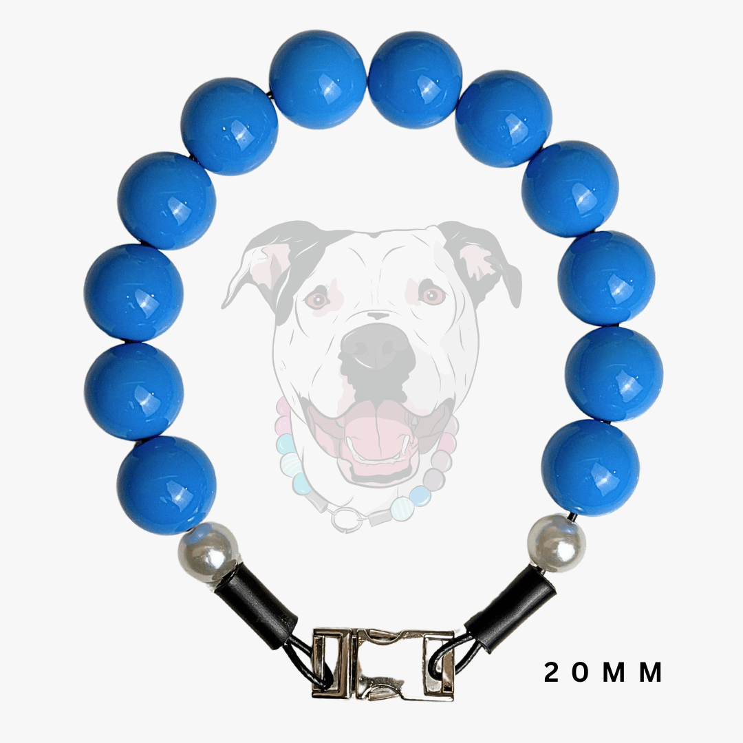 A beaded dog collar featuring glossy blue round beads, a silver-toned metal clasp, and two small white pearl-like accent beads. A faint graphic of a dog wearing the collar is displayed in the background, with '20 MM' text in the bottom right corner.