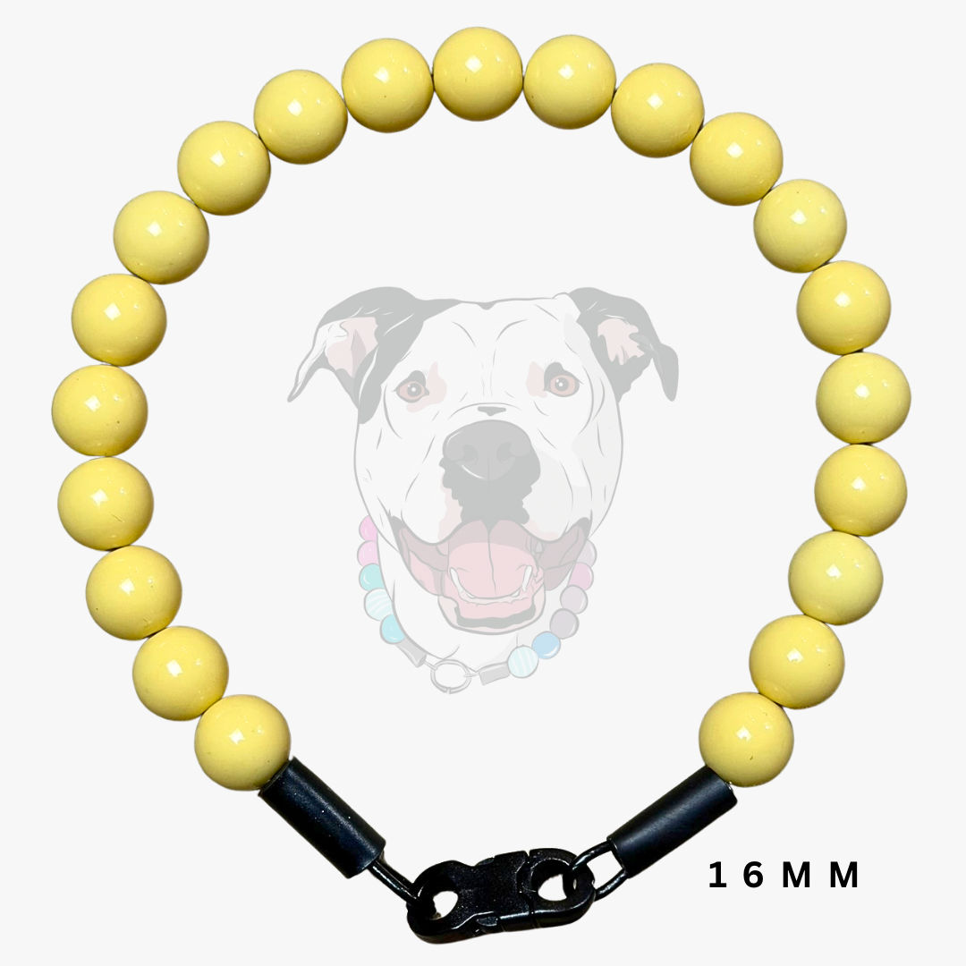 A yellow beaded dog collar with a black clasp and a 16mm width measurement label, shown against a light gray background with a faint dog graphic.