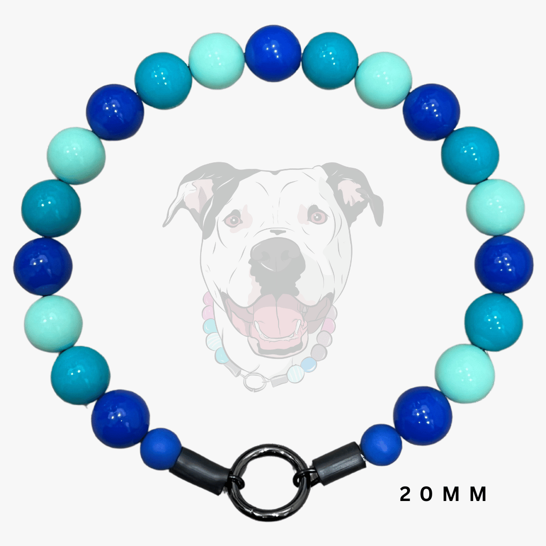 A beaded dog collar necklace made of alternating blue, teal, and mint green round beads, featuring a black metal split ring clasp. A faint graphic of a pitbull dog wearing the collar is displayed in the background, with '20 MM' text in the bottom right corner.