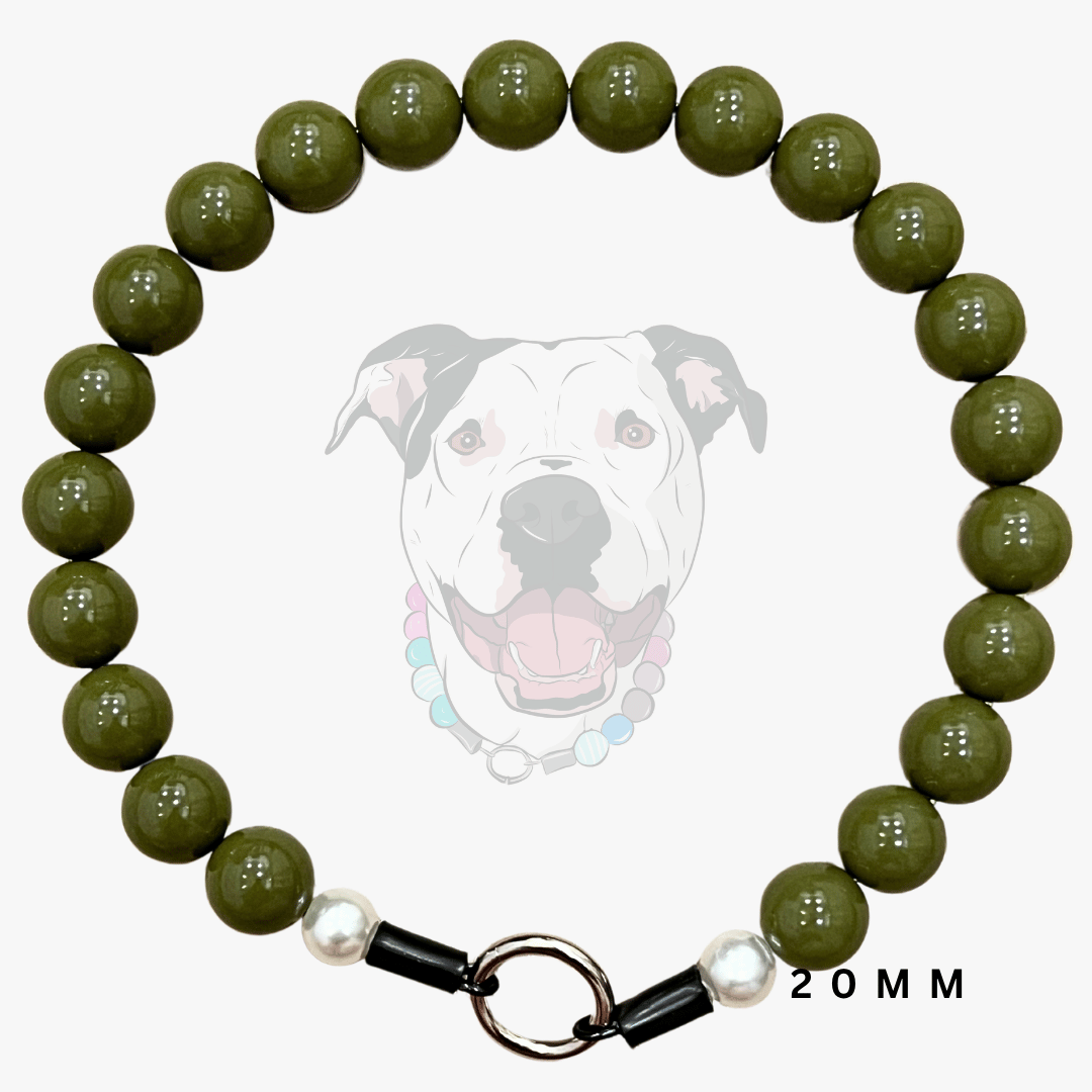 A dog collar made of glossy olive green round beads, featuring a black metal ring clasp with white pearl-like accents. A faint graphic of a dog wearing the collar is displayed in the background, with '20MM' text on the bottom right.