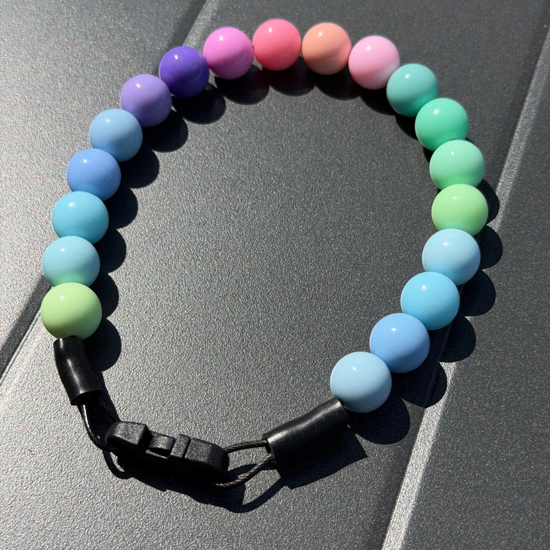POPNCO Pastel Rainbow Beaded Pet Collar laying flat on a Grey Surface 