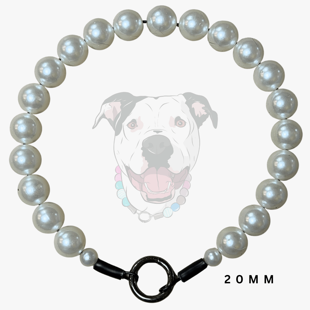 A 20mm pearl collar necklace arranged in a circle, featuring lustrous white pearls and a black toggle clasp, shown against a light gray background with a faint dog illustration and '20MM' text.