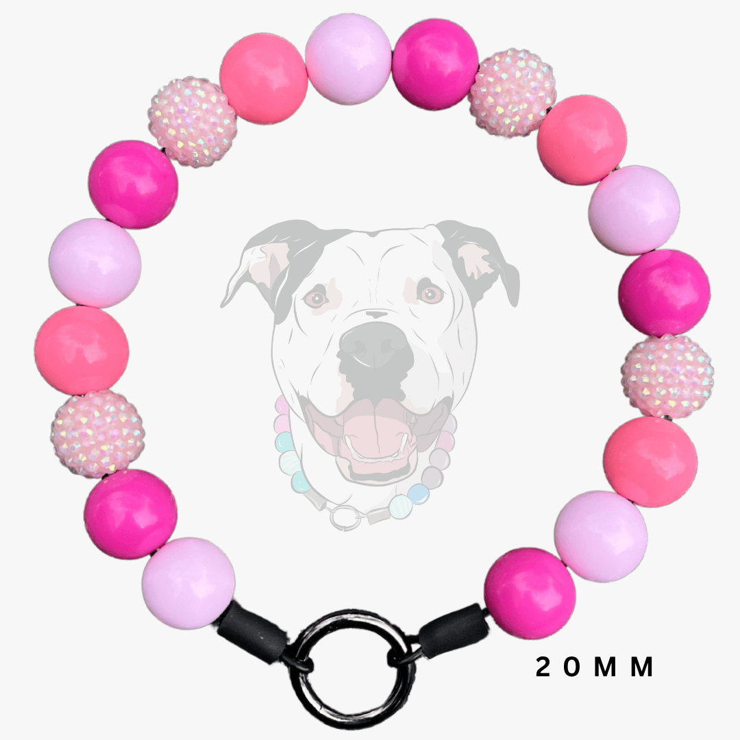 A pink and light purple beaded dog collar with textured rhinestone-like beads and a black metal ring clasp, shown against a light gray background with a faint dog graphic and '20MM' text.